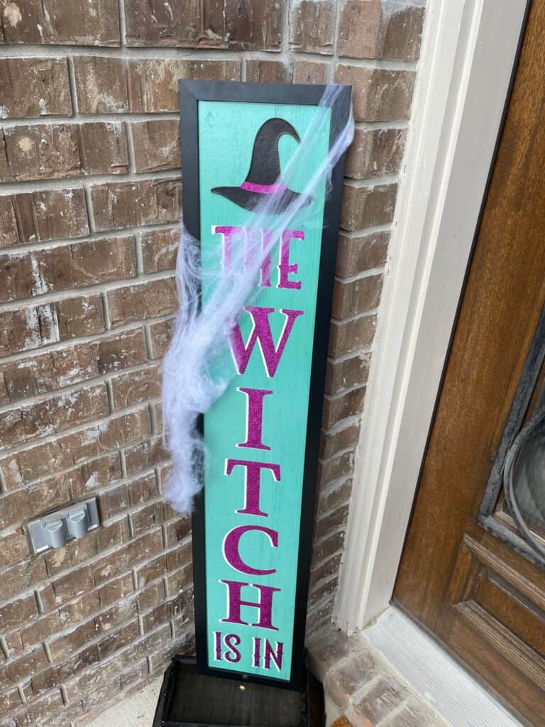 Front porch sign that reads, The Witch Is In 