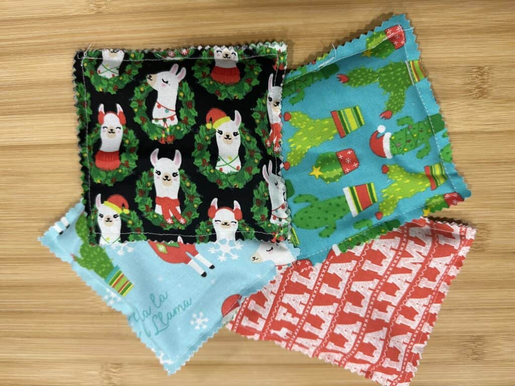 picture of 4 different square rice pack hand warmers sewn from Christmas fabric 
