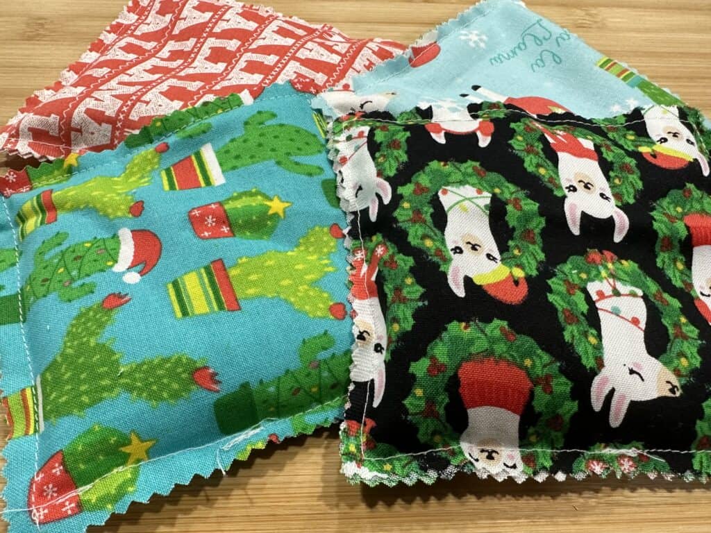 picture of 4 different hand warmers made with Christmas fabric