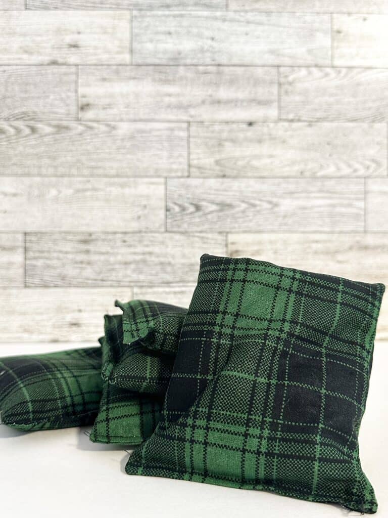 picture of a stack of green and black plaid hand warmers 