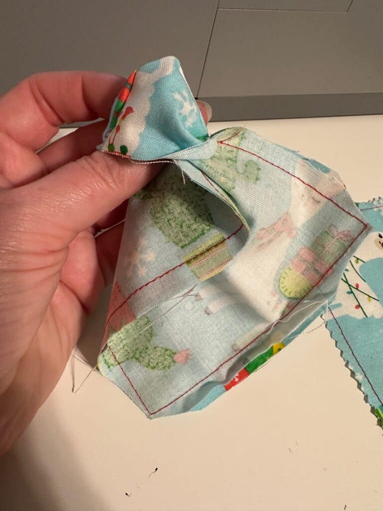 Showing how to turn the fabric right side out after sewing.