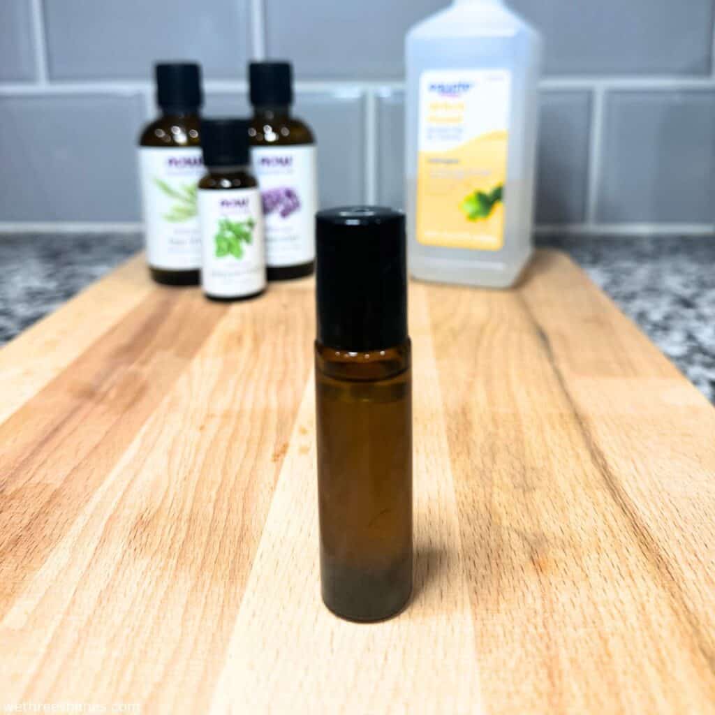 Roller blend bottle filled with homemade bug bite relief essential oils blend.