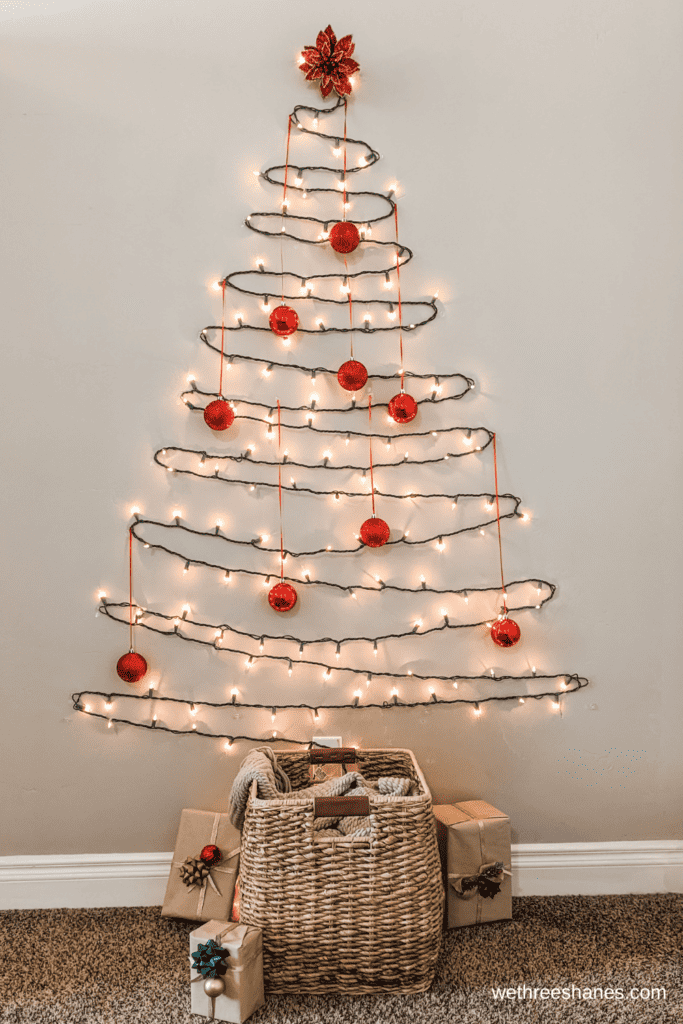 DIY wall Christmas tree with lights and decorations.