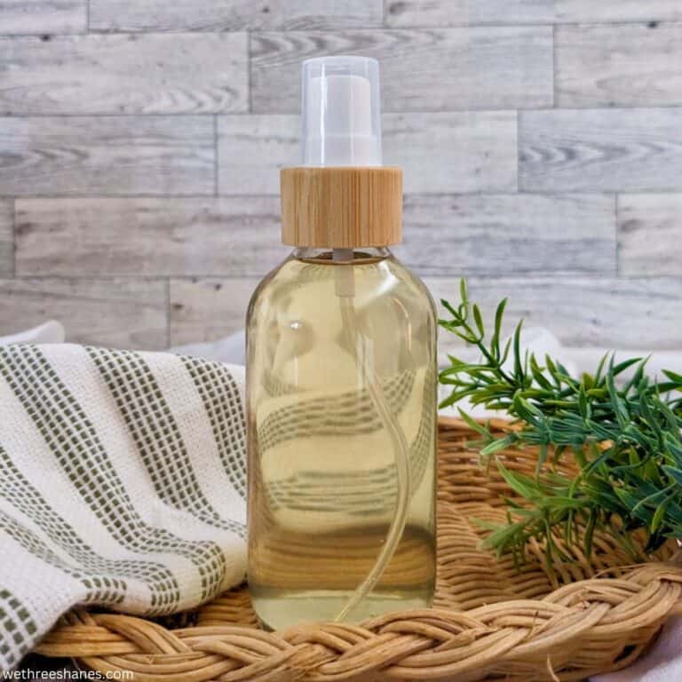 DIY Rosemary Water in a small, glass spray bottle