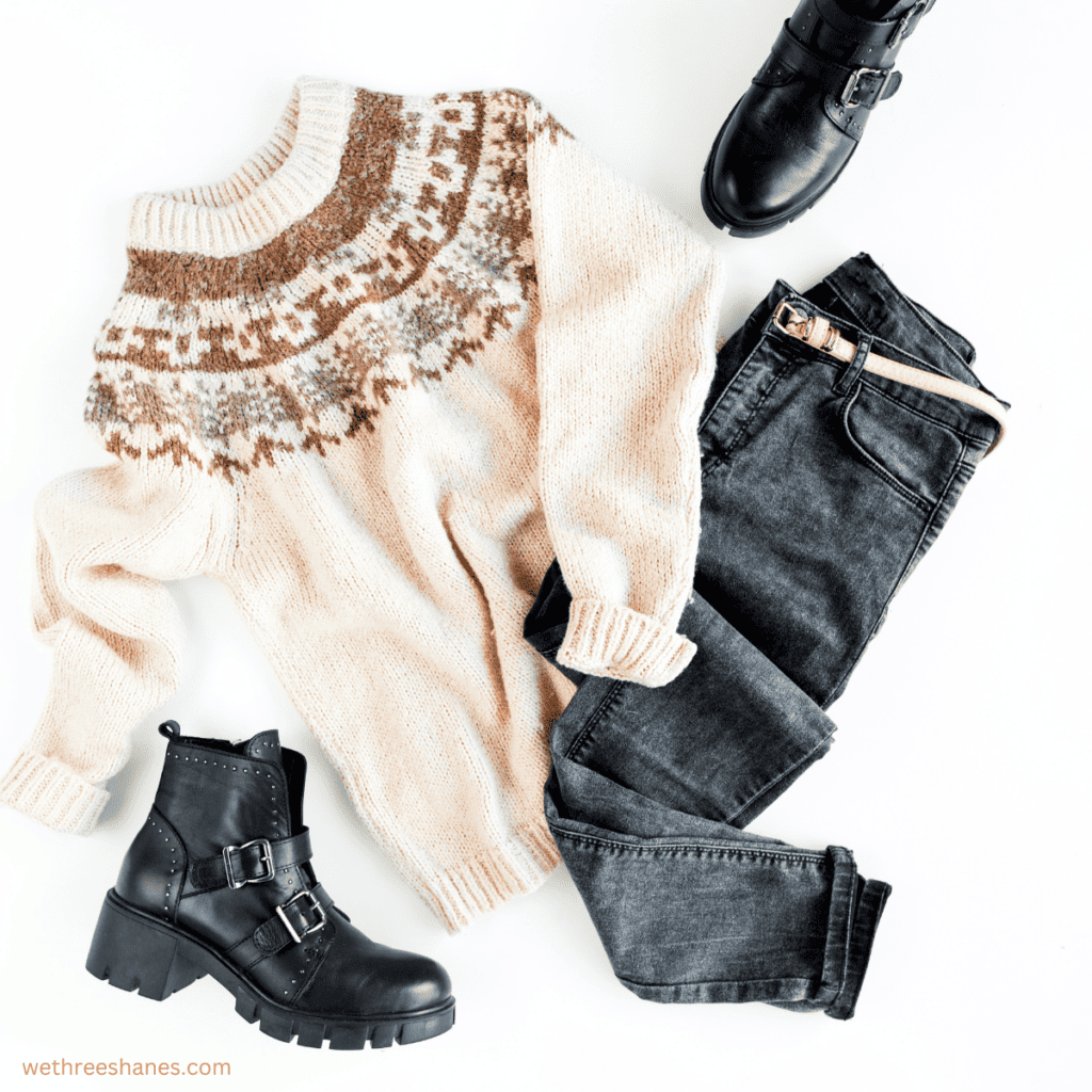 Jeans, boots, and a sweater in fall colors are just one of the possible outfits to make using your fall capsule wardrobe.