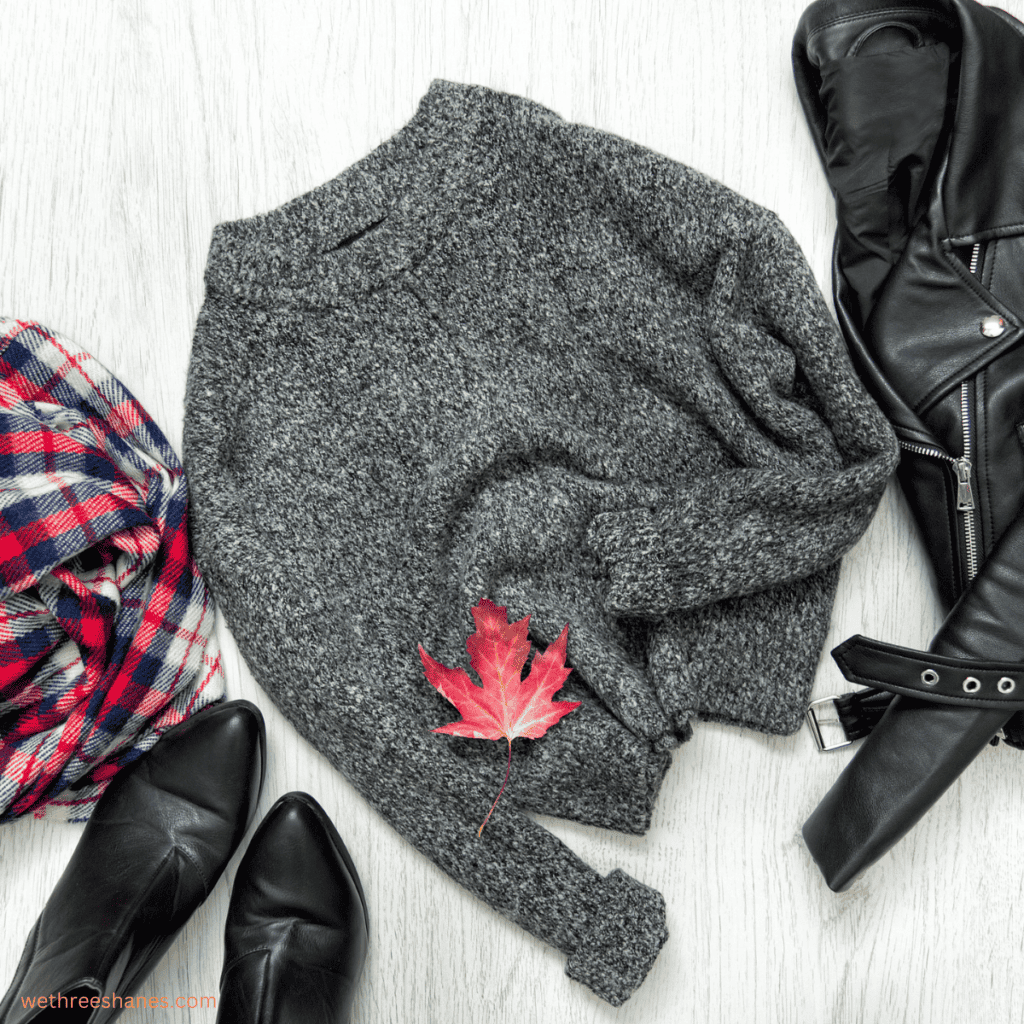 You can accessorize a neutral sweater with block boots, a leather jacket, and a scarf that gives a festive pop of color in your minimal fall wardrobe.