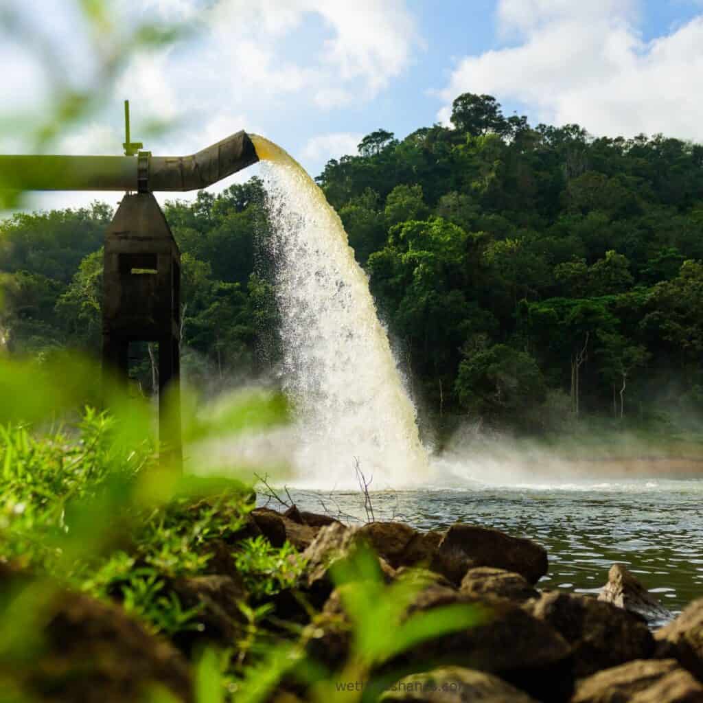 Picture of water being dumped into a water source.  