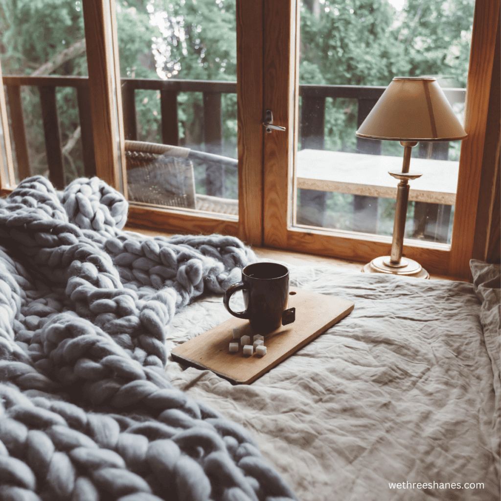 Texture, in the form of a chunky blanket, added to a minimalist room gives the room a cozy feel.