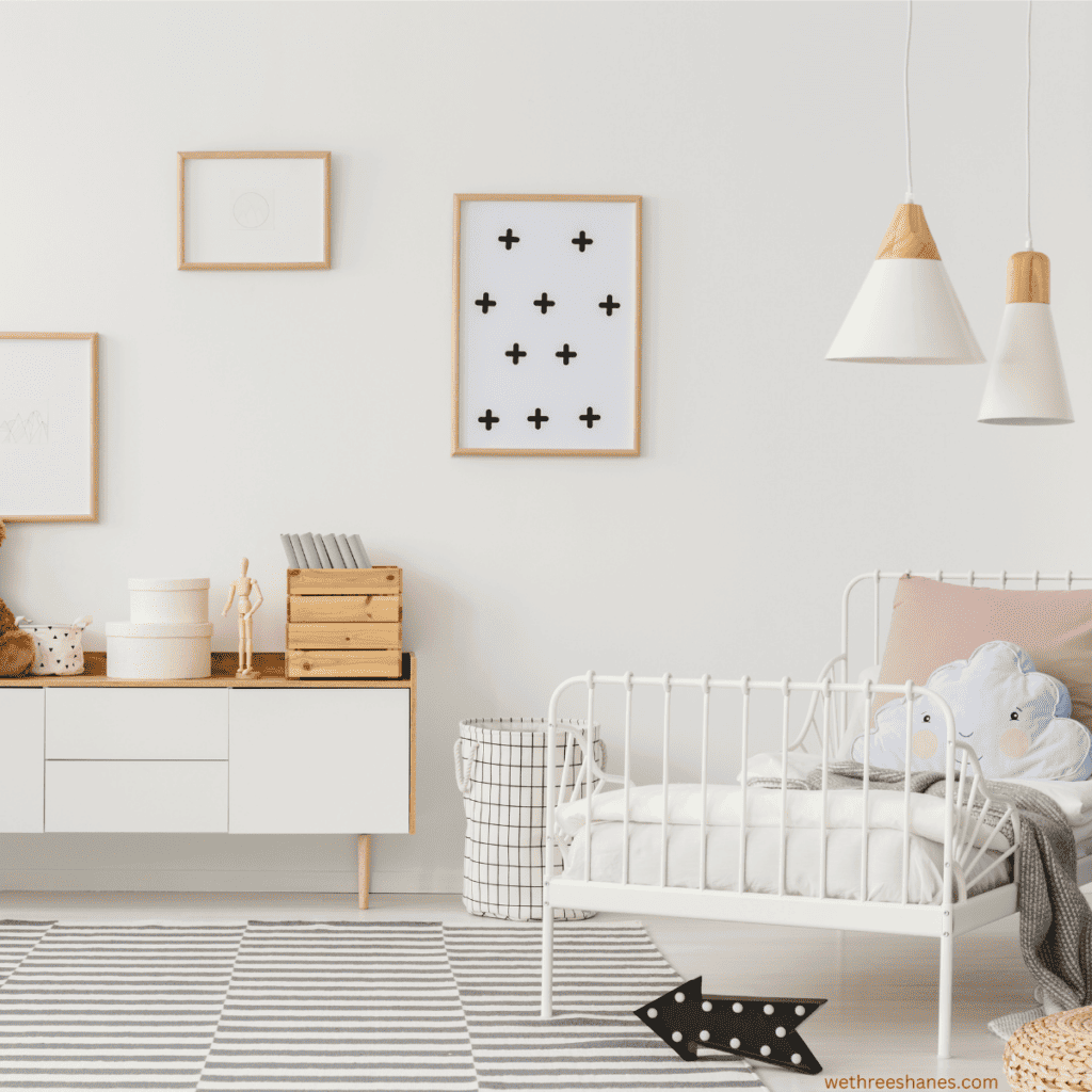 A minimalist kids room that uses soft colors, rugs, and lights to give it a cozy feel.