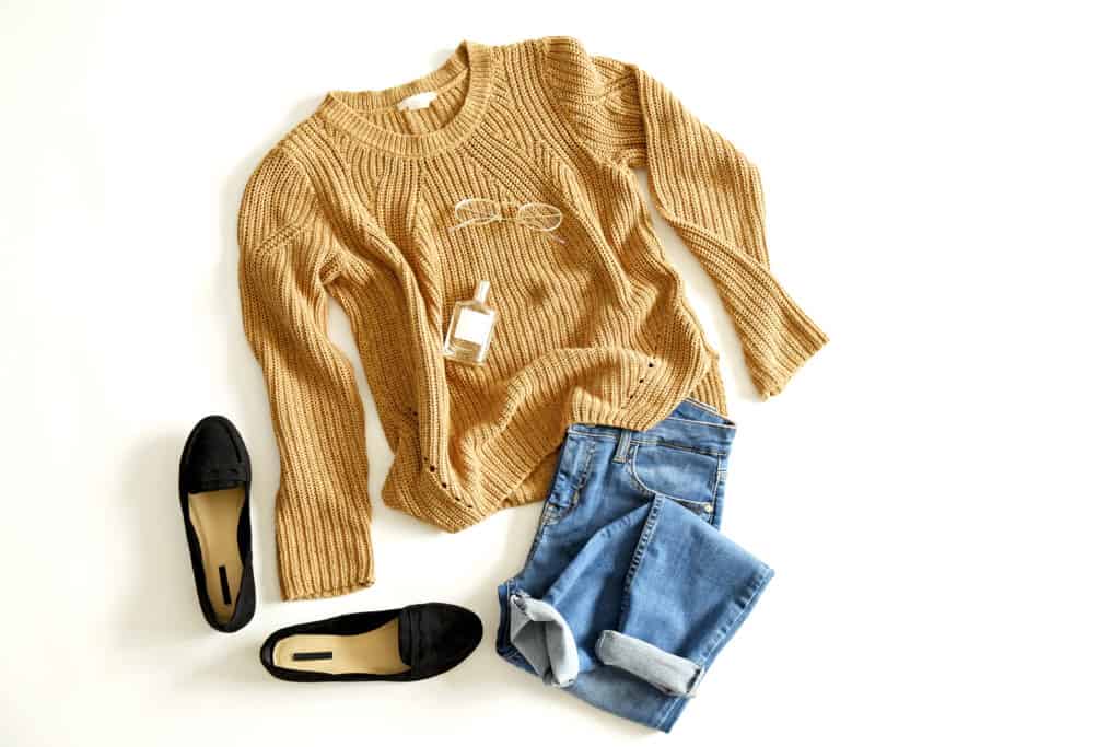 Autumn clothing essentials - gold color sweater, jeans, and black, velvet loafers.