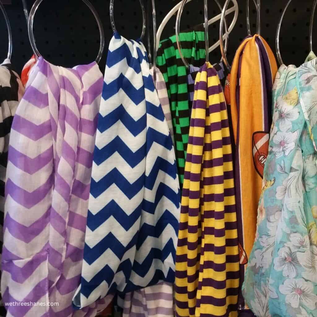 Scarves hanging from some plastic shower curtain rings